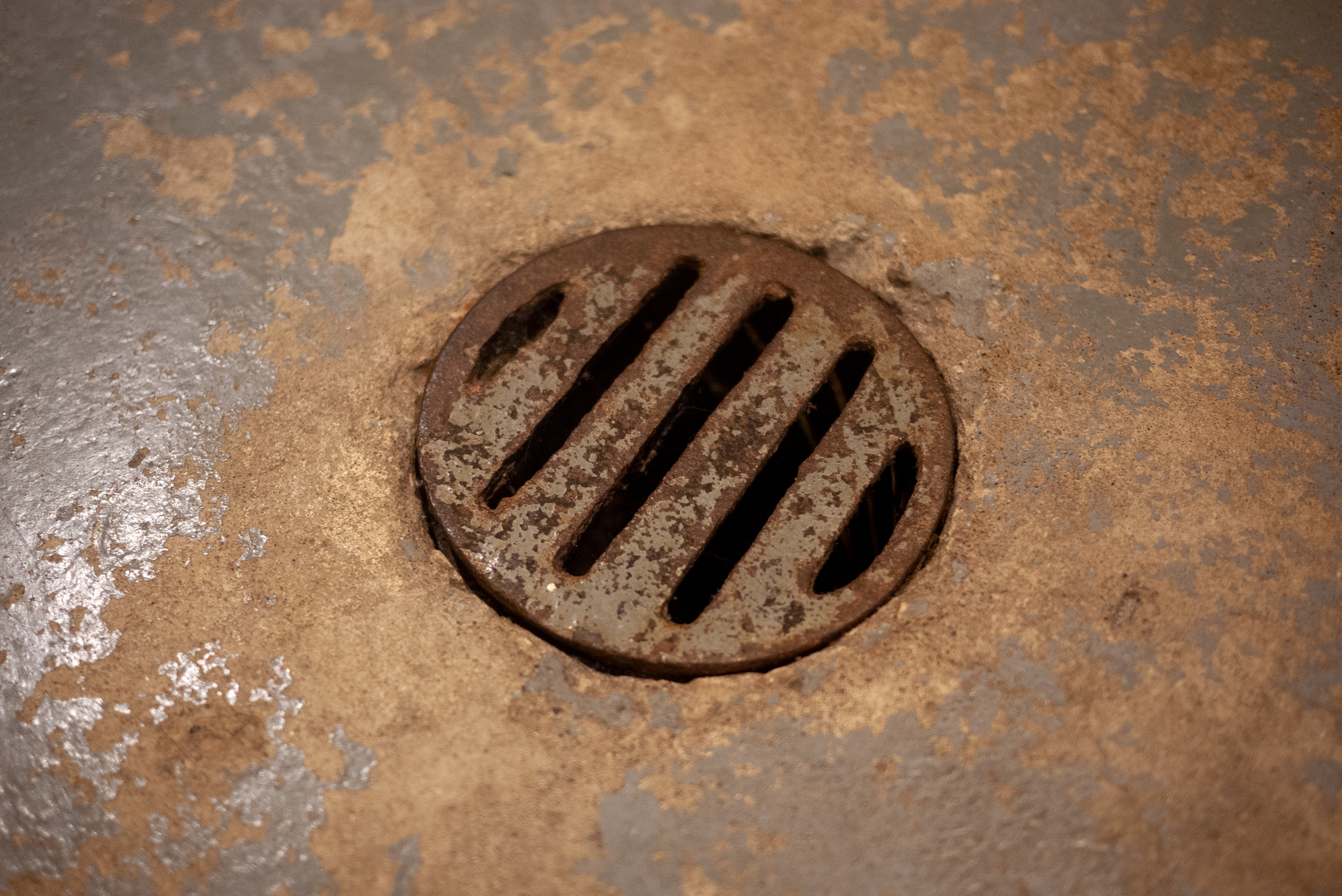 Close up of rusted basement floor drain
