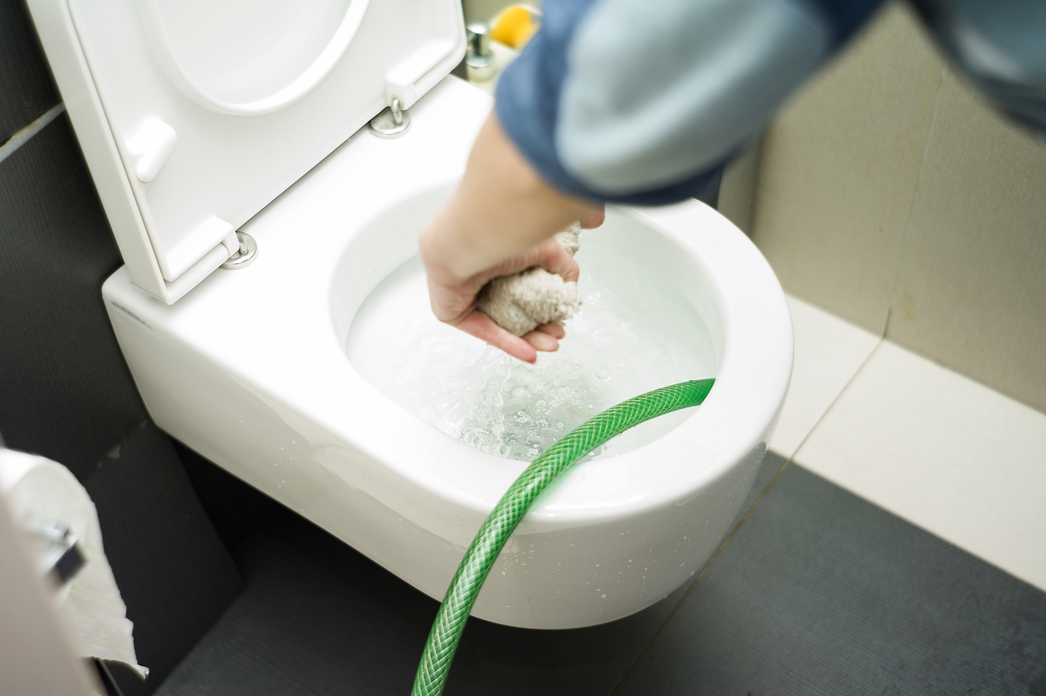 Toilet Overflowing with a hose trying to drain water